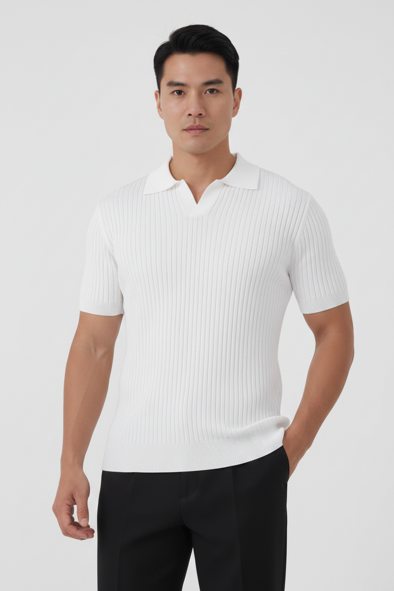 Man wearing a white ribbed polo shirt and black pants on a white background