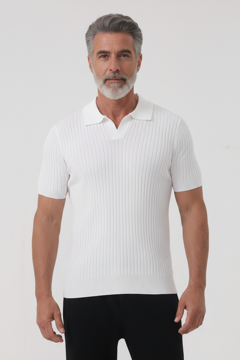 Man wearing a white ribbed polo shirt and black pants on a light gray background