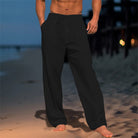 Person wearing black pants on a beach at night
