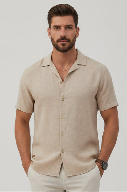 Man wearing a beige short-sleeve shirt on a light gray background