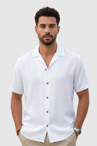 Man wearing a white short-sleeve shirt on a light gray background