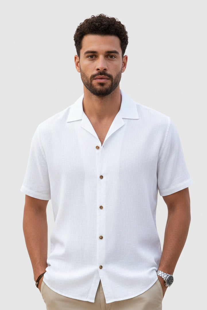 Man wearing a white short-sleeve shirt on a light gray background