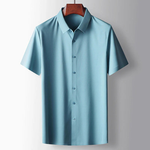 Light blue short-sleeve shirt on a hanger against a gray background