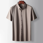 Beige short-sleeve shirt on a hanger against a light gray background