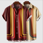 Two short-sleeve shirts with colorful striped patterns on hangers against a white background.