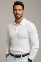 Man wearing a white ribbed sweater with a blurred background