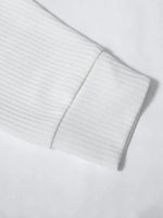 Close-up of a light gray ribbed sweater sleeve on a white background