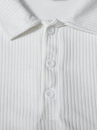 Close-up of a white ribbed shirt with buttons