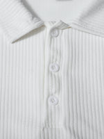 Close-up of a white ribbed shirt with buttons