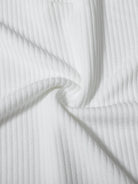 Close-up of white ribbed fabric with folds