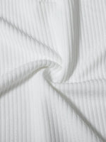 Close-up of white ribbed fabric with folds