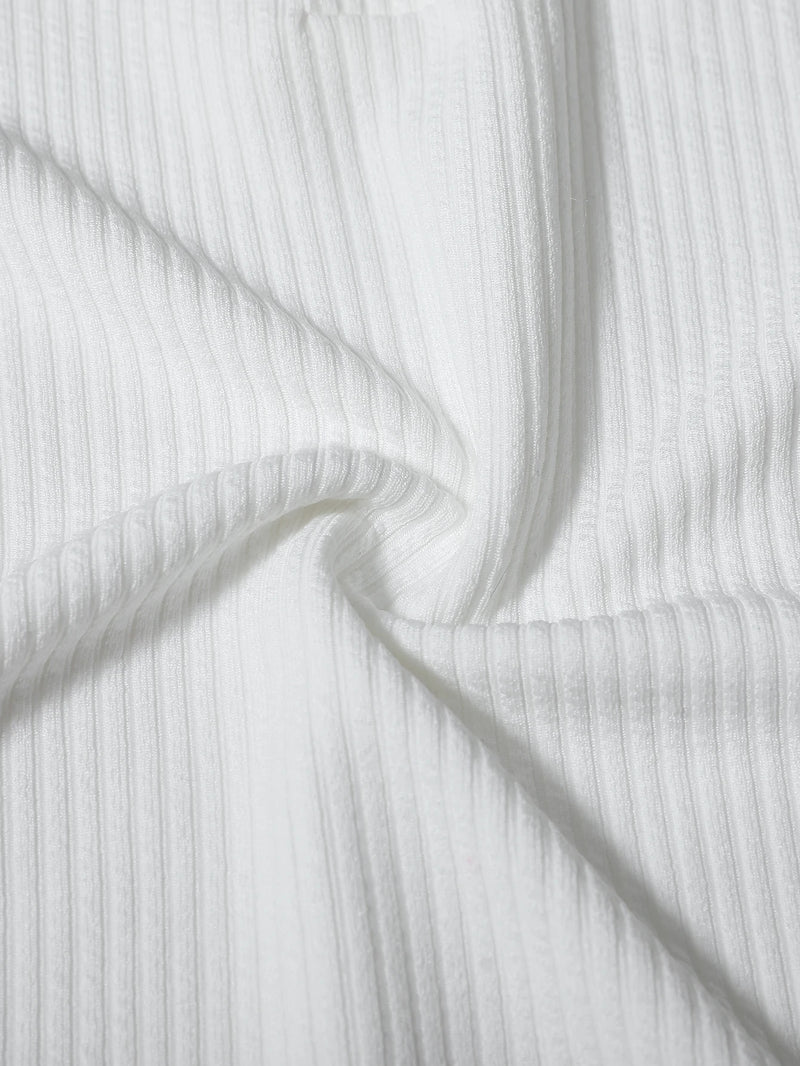 Close-up of white ribbed fabric with folds