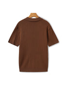 Brown ribbed sweater on a hanger against a white background