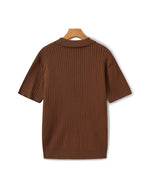 Brown ribbed sweater on a hanger against a white background