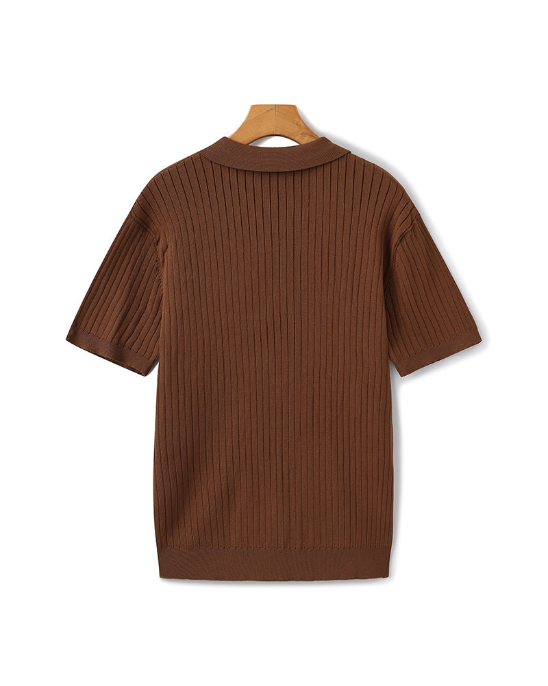 Brown ribbed sweater on a hanger against a white background