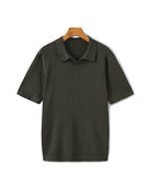 Dark green ribbed polo shirt on a hanger against a white background