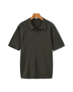 Dark green ribbed polo shirt on a hanger against a white background