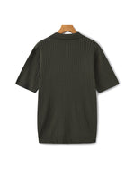 Dark green ribbed sweater on a hanger against a white background