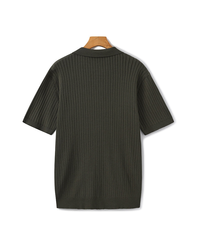 Dark green ribbed sweater on a hanger against a white background