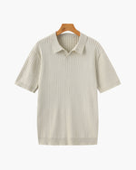 Beige ribbed knit polo shirt on a hanger against a white background