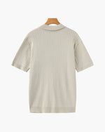 Beige ribbed knit dress on a hanger against a white background