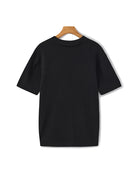 Black ribbed sweater on a wooden hanger against a white background