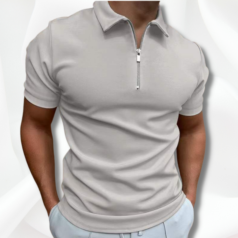 Man wearing a light gray short-sleeve polo shirt with a quarter zip on a white background