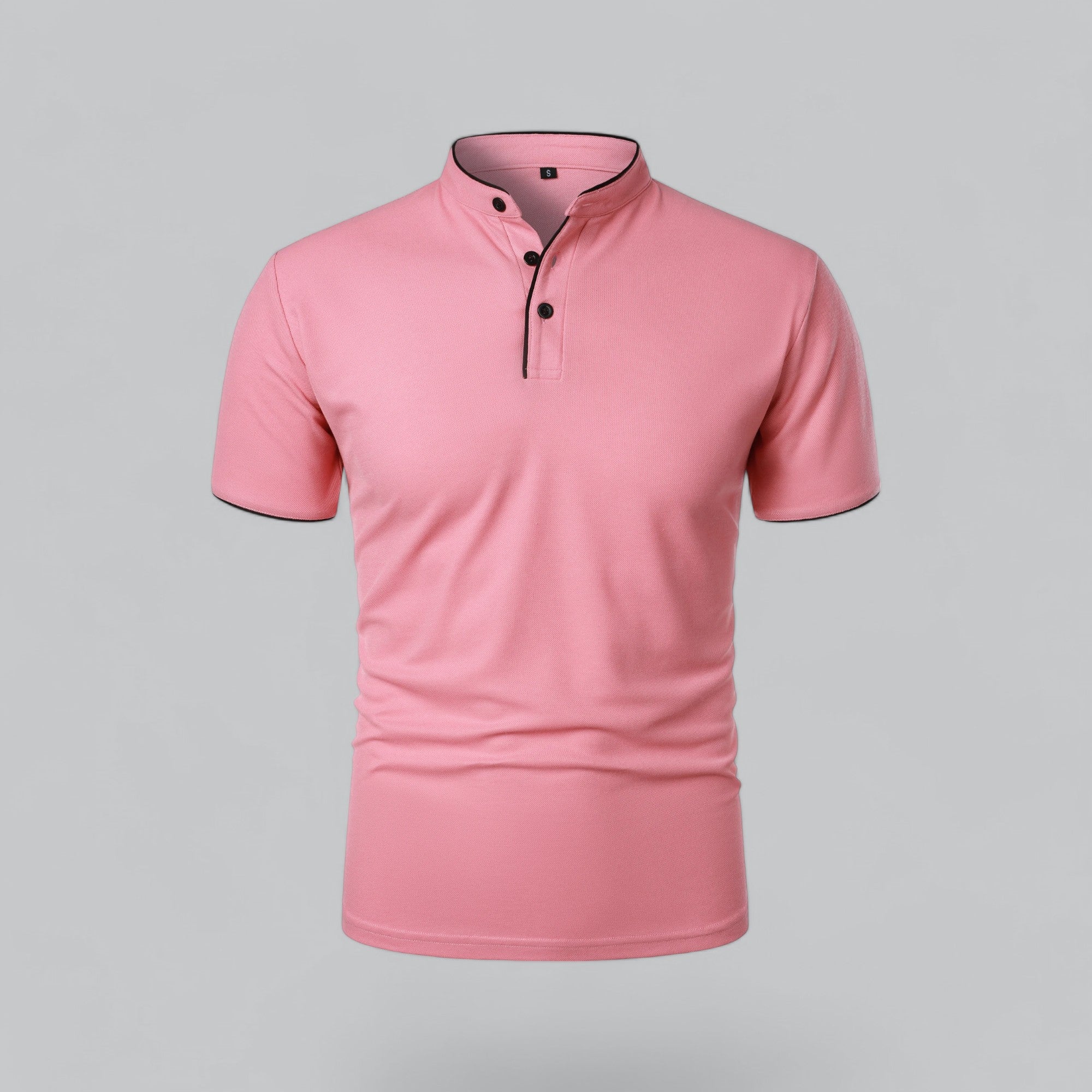 Pink polo shirt with black buttons on a gray background