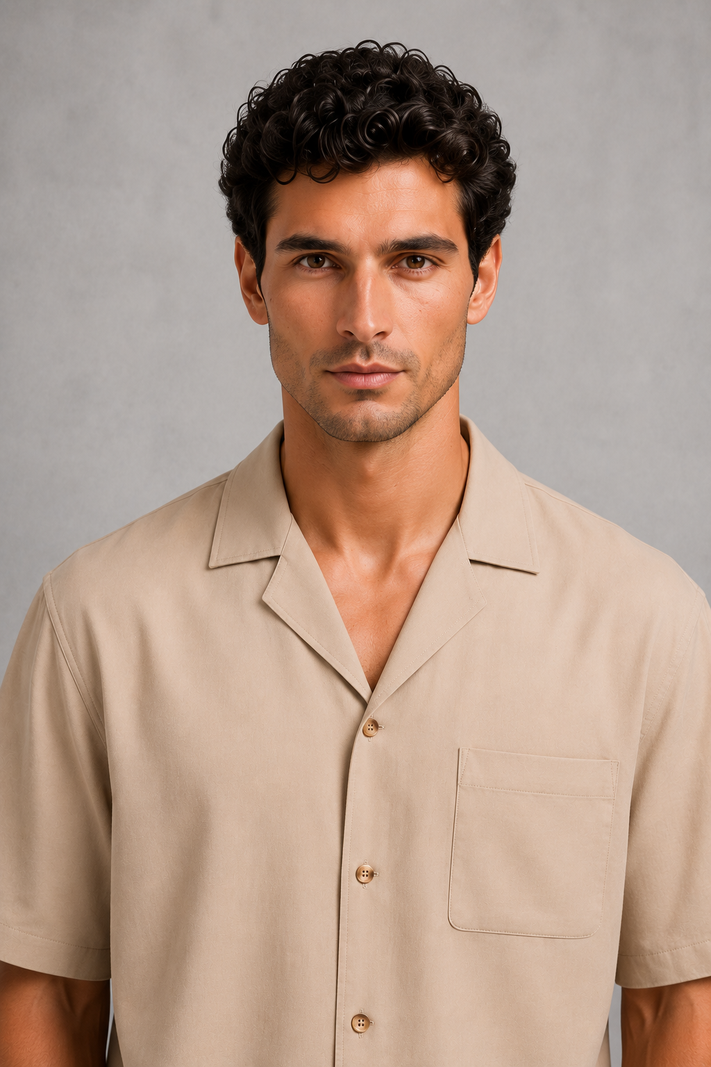 Man wearing a beige shirt against a gray background
