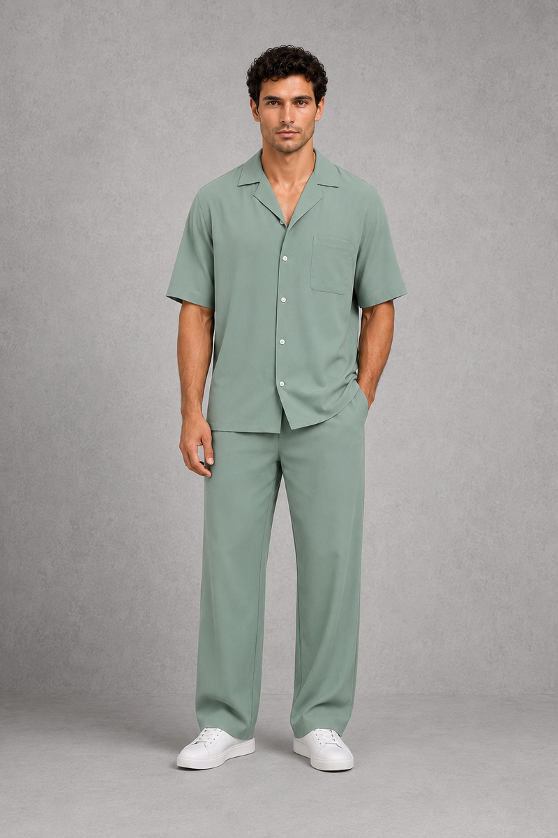 Man wearing a green pajama set against a gray background
