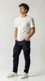 Man wearing a white t-shirt and black pants on a plain background