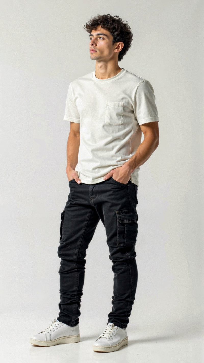 Man wearing a white t-shirt and black pants on a plain background
