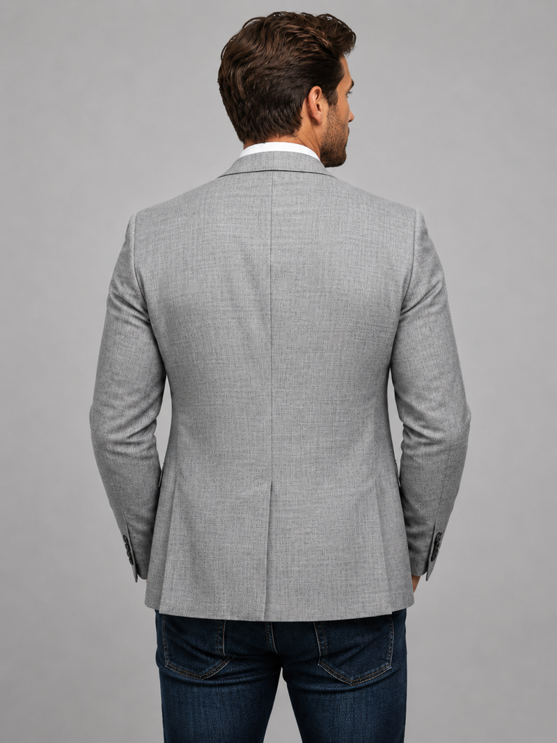 Man wearing a gray checkered blazer on a gray background