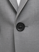 Close-up of a gray suit jacket with a button