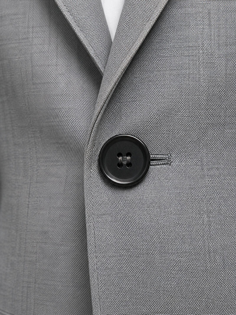 Close-up of a gray suit jacket with a button