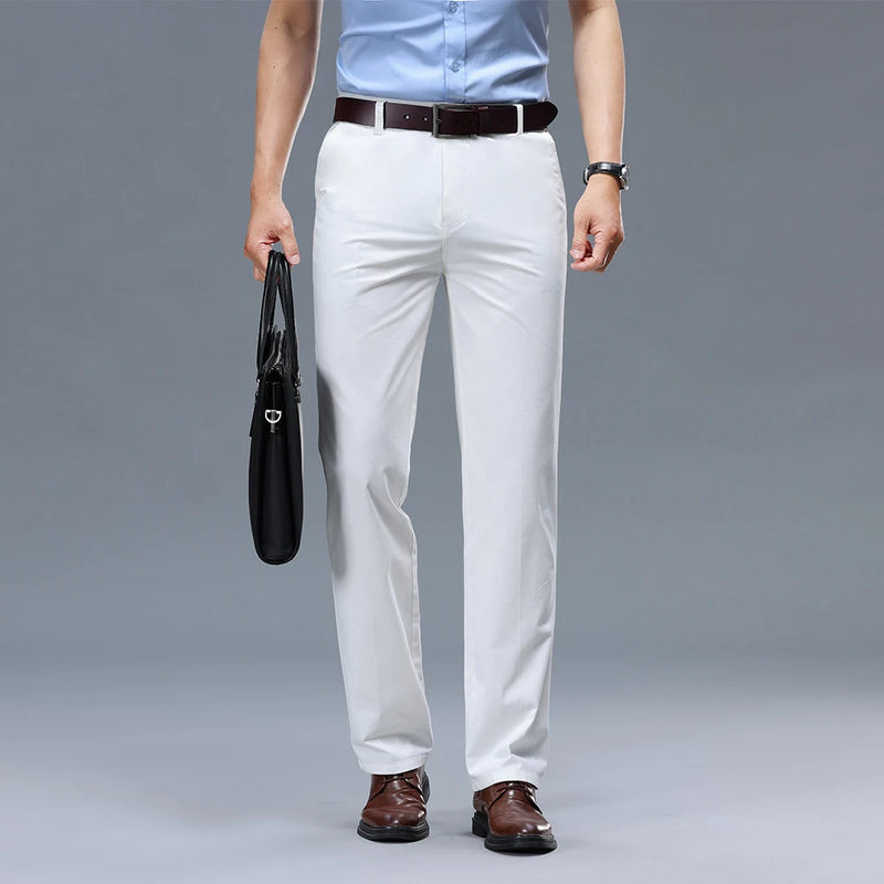Person wearing white pants, a light blue shirt, and brown shoes on a gray background