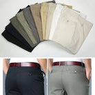 Collection of men's dress pants in various colors with a person wearing them.