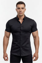 Man wearing a black shirt standing by a pool