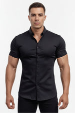 Man wearing a black shirt standing by a pool