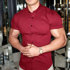 Man wearing a red short-sleeve shirt with a reflective background
