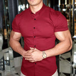 Man wearing a red short-sleeve shirt with a reflective background