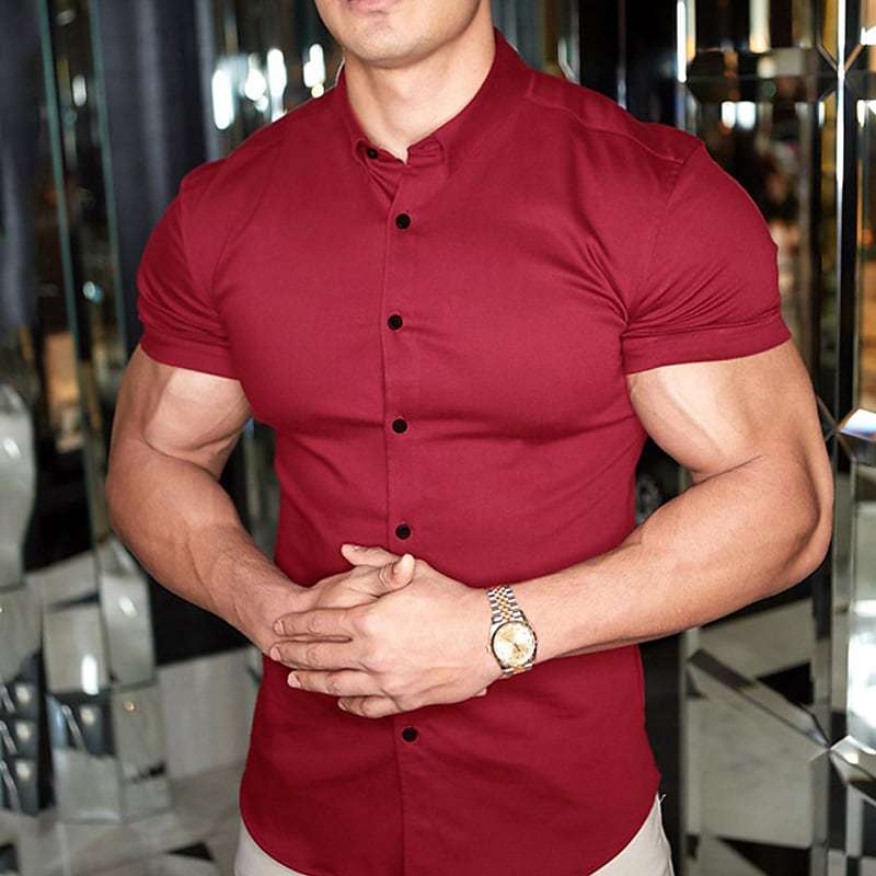 Man wearing a red short-sleeve shirt with a reflective background