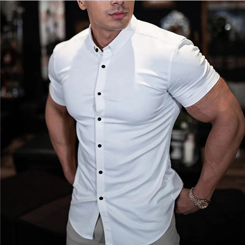 Man wearing a white short-sleeve button-up shirt with a blurred background