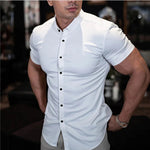 Man wearing a white short-sleeve button-up shirt with a blurred background