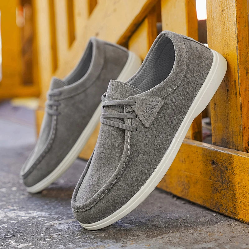 Gray loafers on a wooden surface