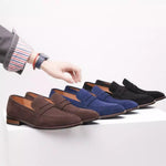 Three pairs of loafers in brown, blue, and black on a white surface.