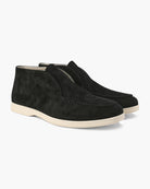Pair of black suede shoes on a white background