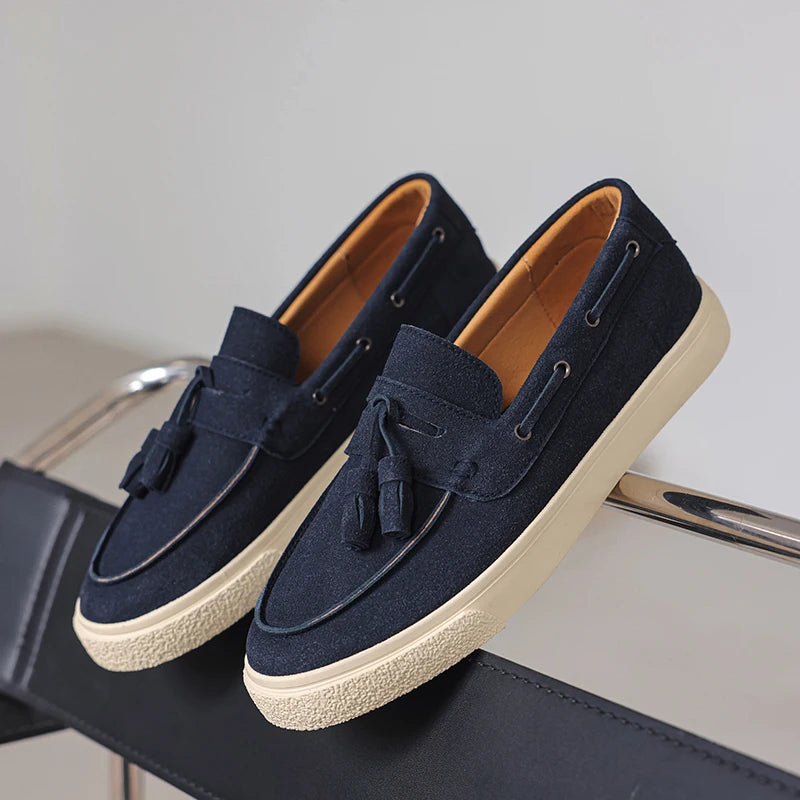 Navy loafers with white soles on a chair