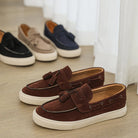 Brown loafers on a wooden floor with a neutral background
