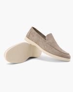 Beige loafers on a white background
